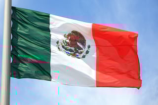 Mexican national flag waving in the sky