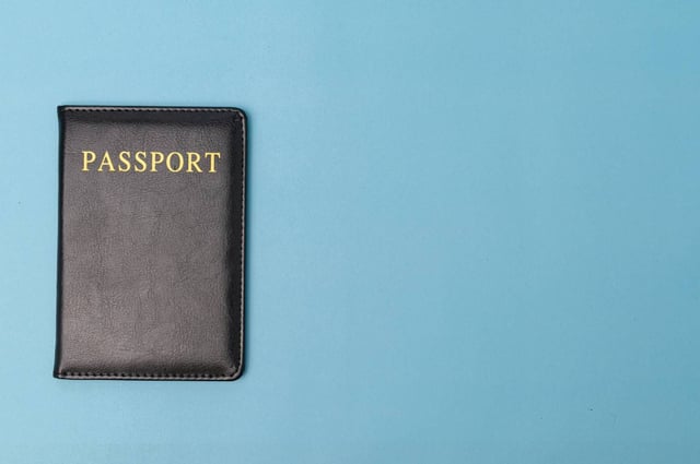A Passport Against A Blue Background