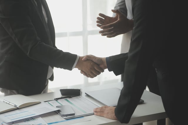 Businessmen shaking hands over a completed deal