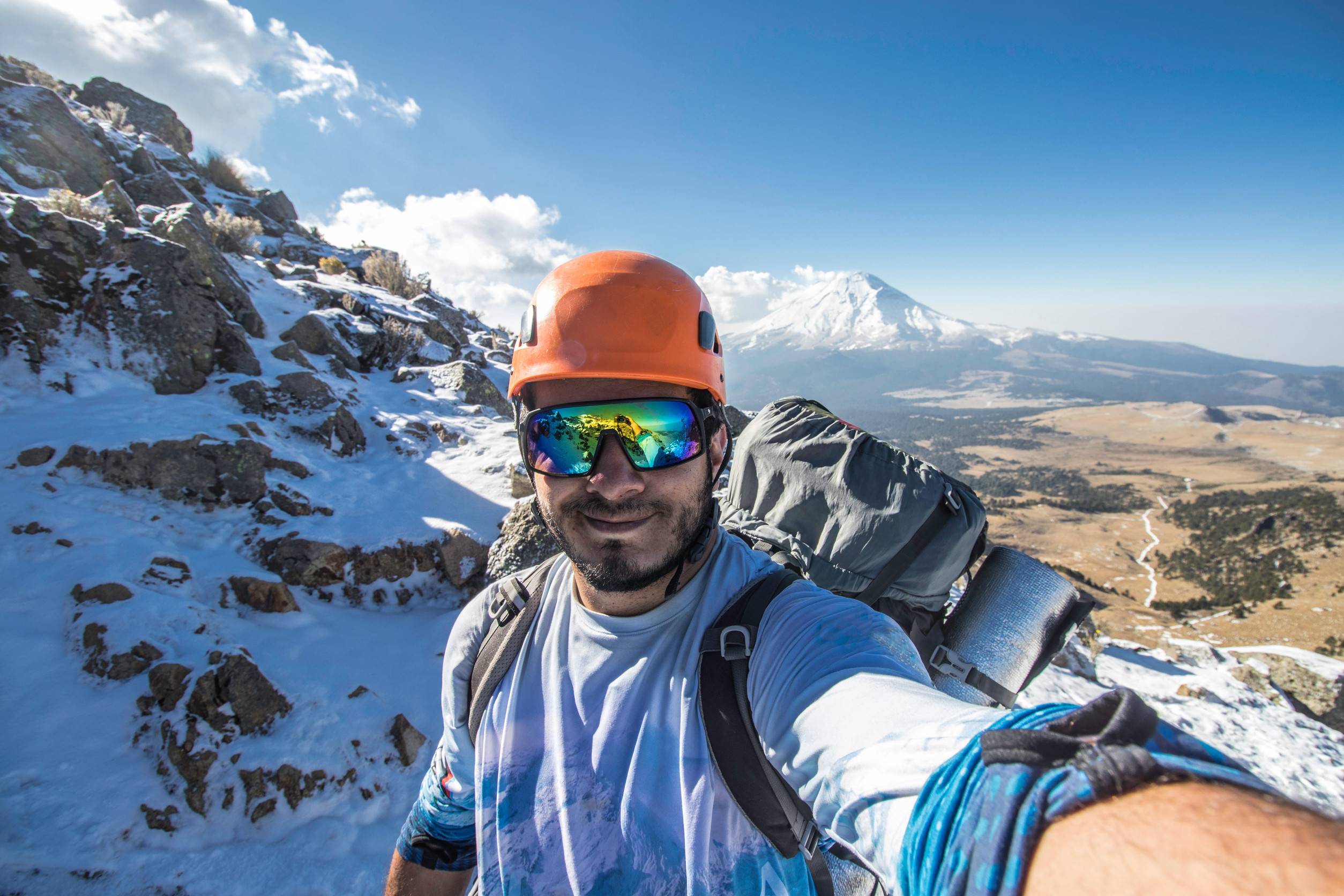 A Mountaineer Taking A Selfie Against An Active Volcano In Mexico