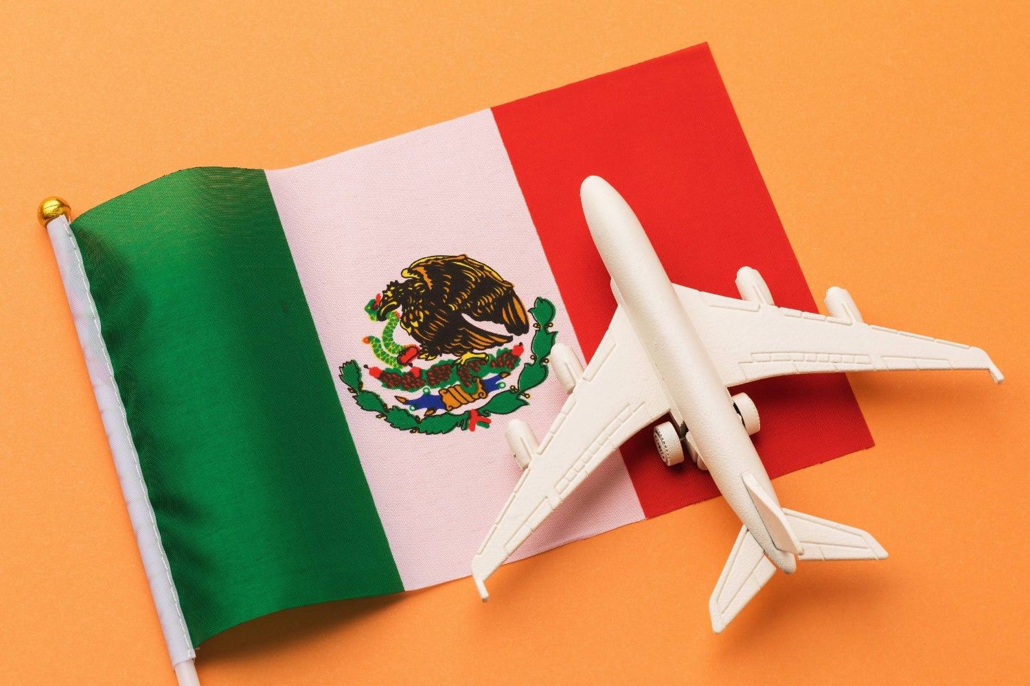 A Toy Plane On A Mexican Flag
