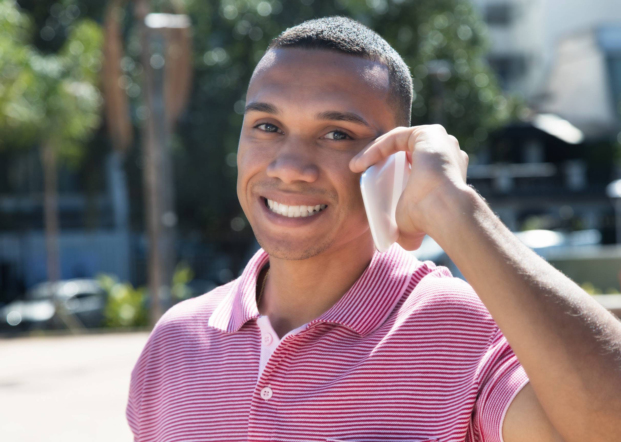 A young guy talking on a phone