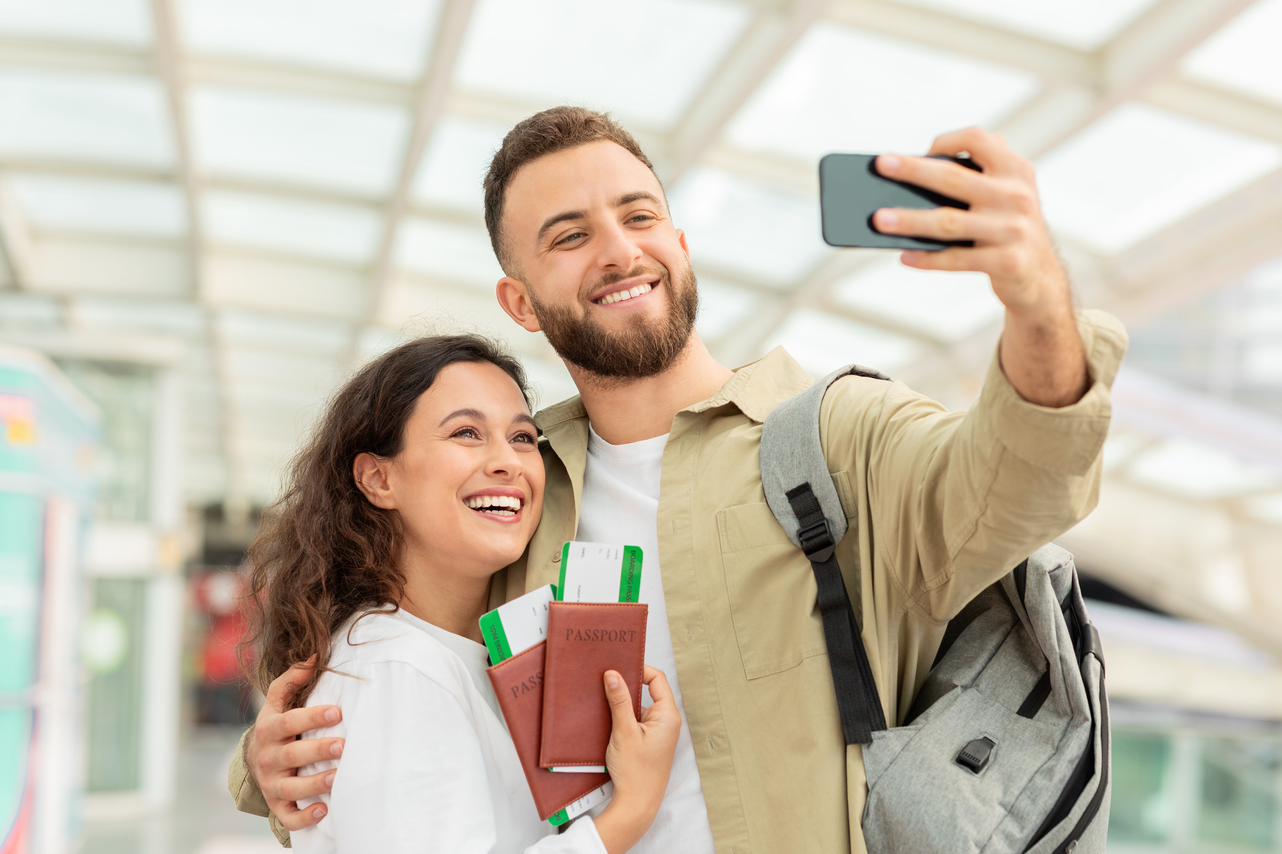 Man And Woman Taking Selfie On Smartphone In Airport