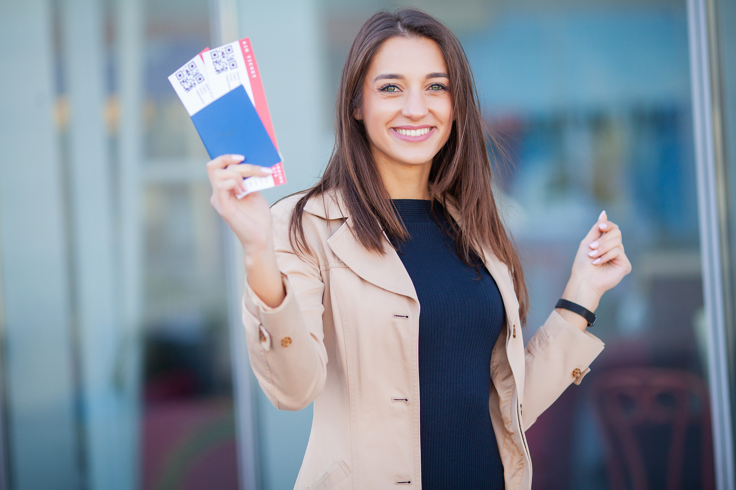 Woman Having Beautiful Brown Hair Smiling While Holding Passport And Air Tickets