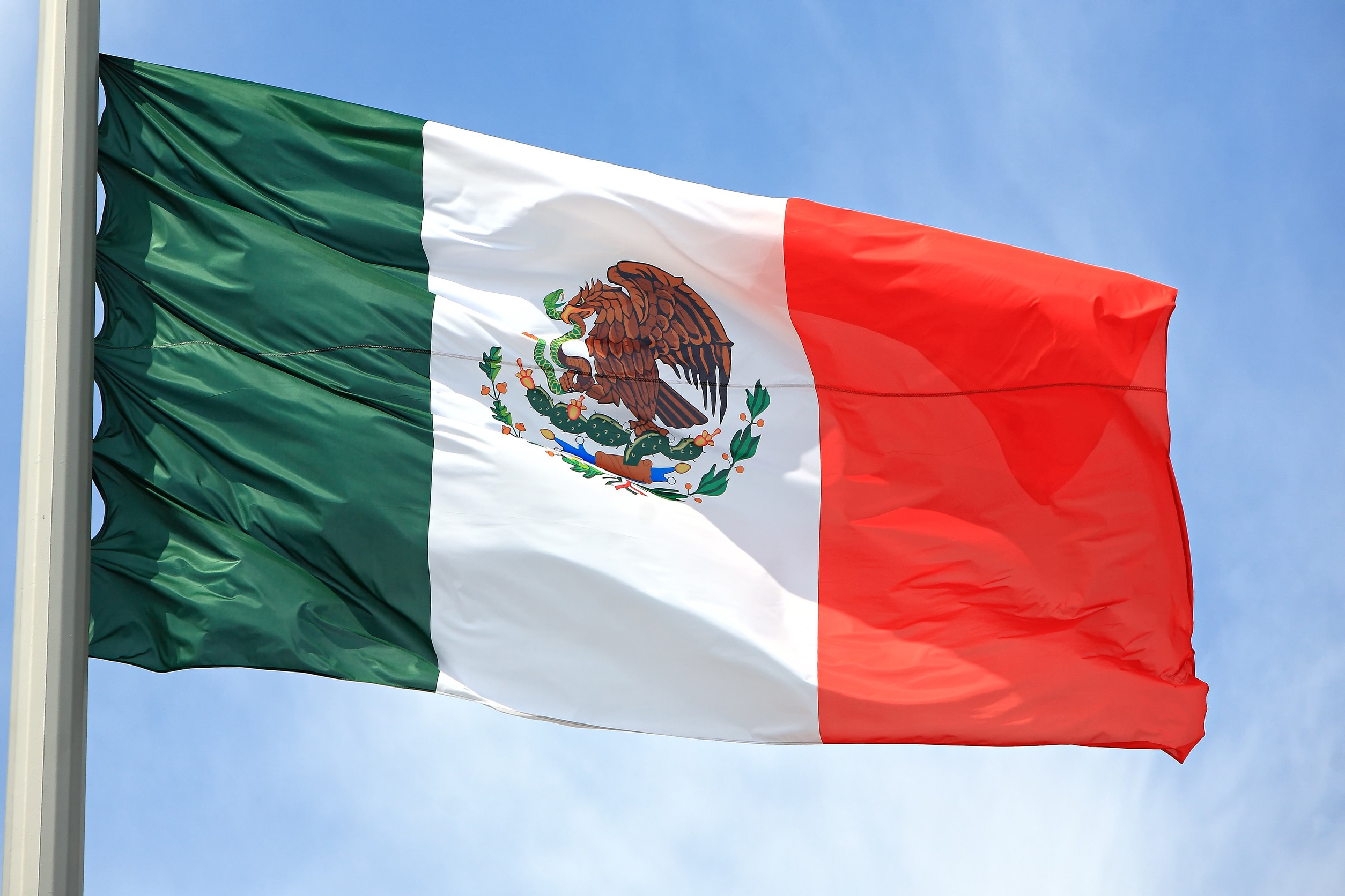 Mexican national flag waving in the sky Mexican national flag waving in the sky