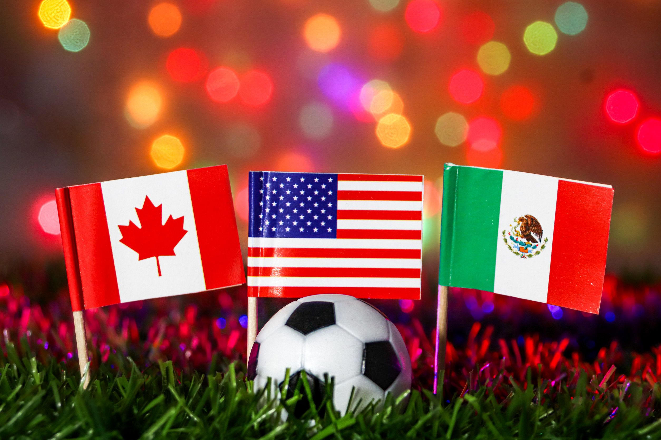 Soccer football with national flags of Canada, USA, and Mexico